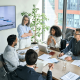 Sales team manager coaching reps during a performance review meeting